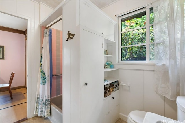 full bathroom featuring shower / bath combo and toilet