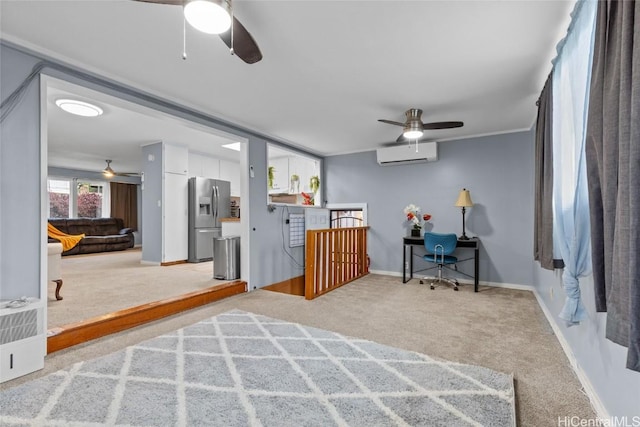 interior space with crown molding, an AC wall unit, carpet flooring, stainless steel fridge, and baseboards