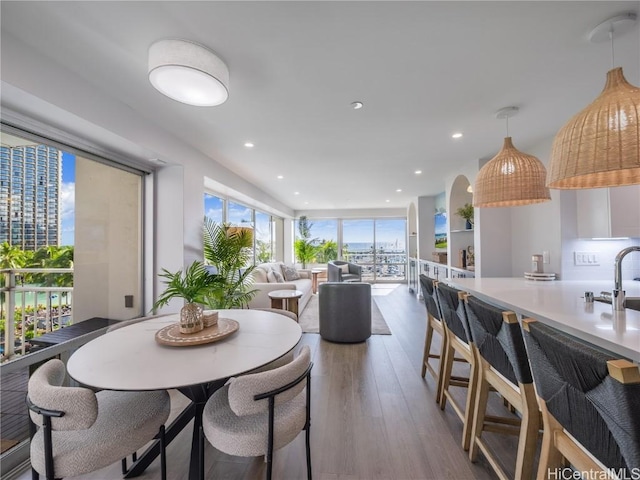 dining space with recessed lighting and wood finished floors