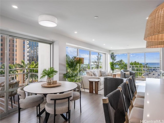 dining space featuring recessed lighting, plenty of natural light, and wood finished floors