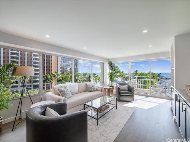 living area with light wood-style floors and recessed lighting