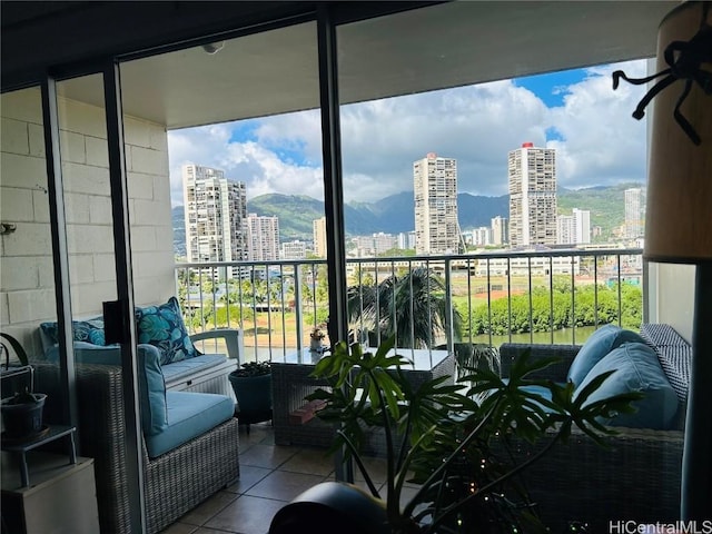 balcony with a mountain view and a city view