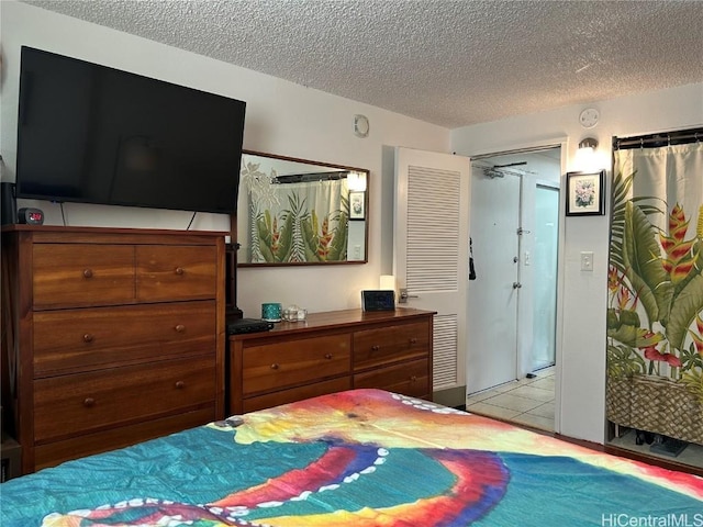 tiled bedroom with a textured ceiling