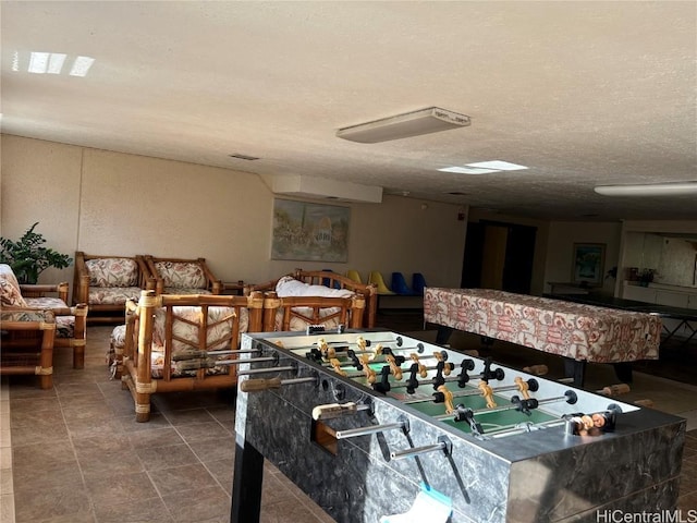 game room featuring visible vents and a textured ceiling