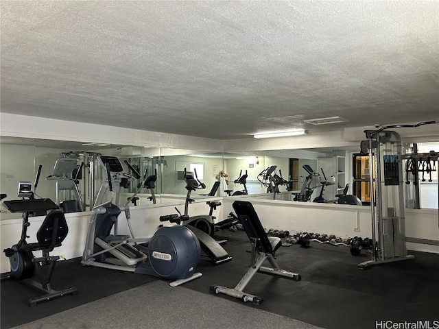 workout area with a textured ceiling