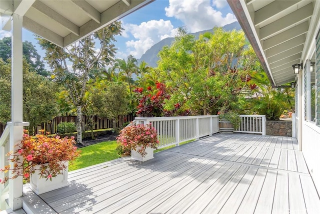 deck with fence and a mountain view