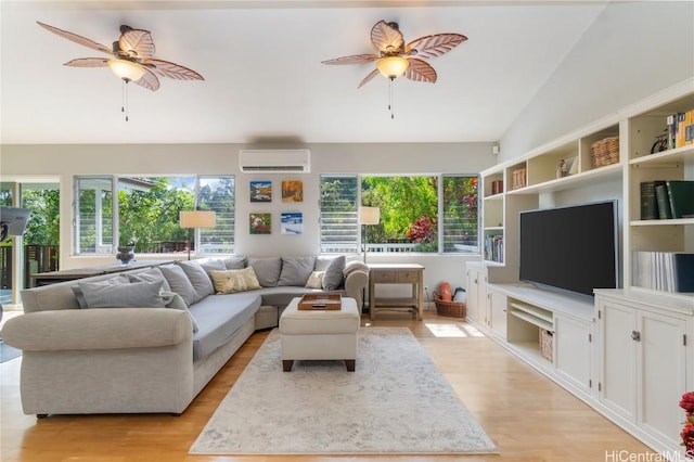 living area with a wealth of natural light, a ceiling fan, and an AC wall unit