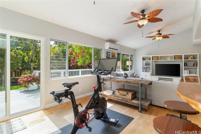 workout room featuring a wall unit AC, light wood finished floors, baseboards, and vaulted ceiling