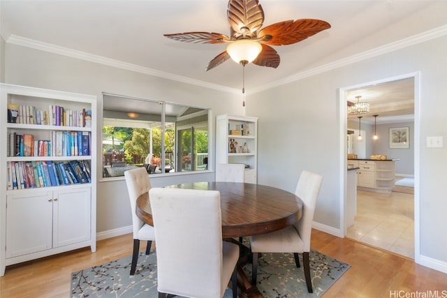 dining space featuring light wood finished floors and ornamental molding