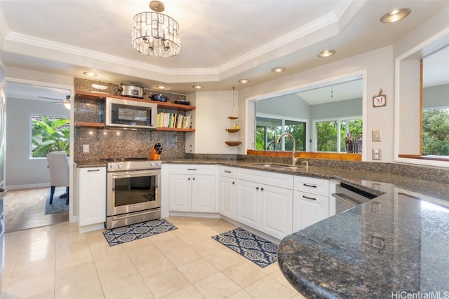 kitchen featuring white cabinets, decorative backsplash, appliances with stainless steel finishes, open shelves, and a sink