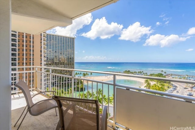 balcony featuring a water view and a beach view