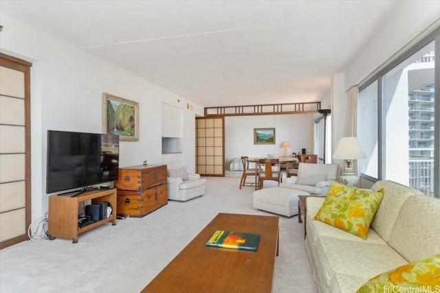 living room featuring a healthy amount of sunlight and carpet flooring