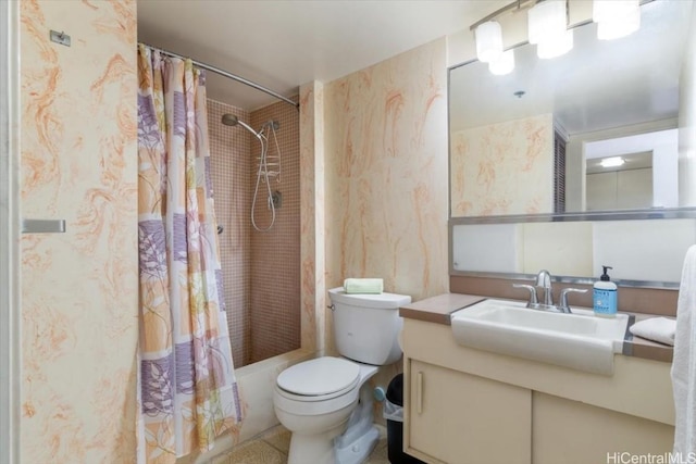 bathroom with toilet, wallpapered walls, shower / bath combo, and vanity