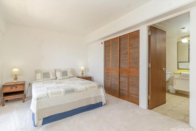 carpeted bedroom featuring connected bathroom and a closet