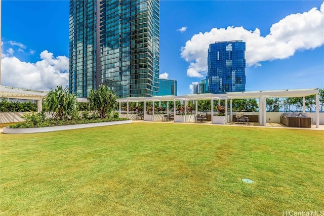 view of home's community featuring a patio area, a city view, a pergola, and a yard