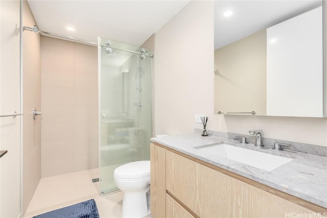 bathroom with vanity, toilet, recessed lighting, and a stall shower