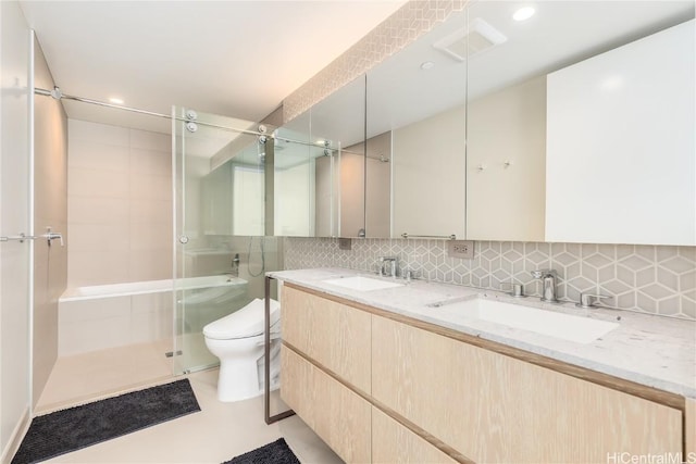 bathroom featuring visible vents, a shower stall, decorative backsplash, and a sink