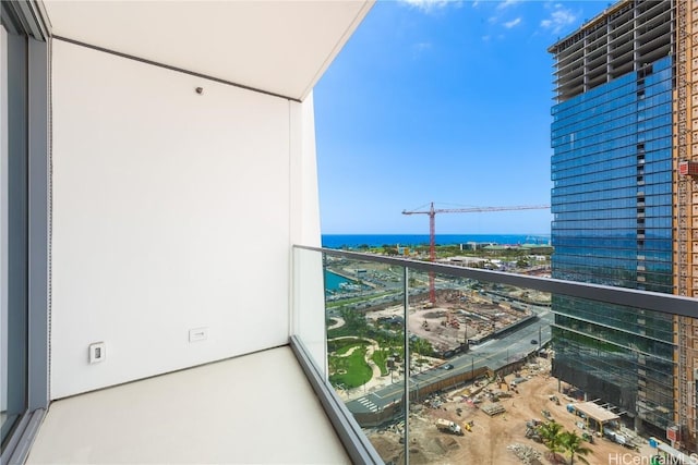 balcony with a water view and a city view