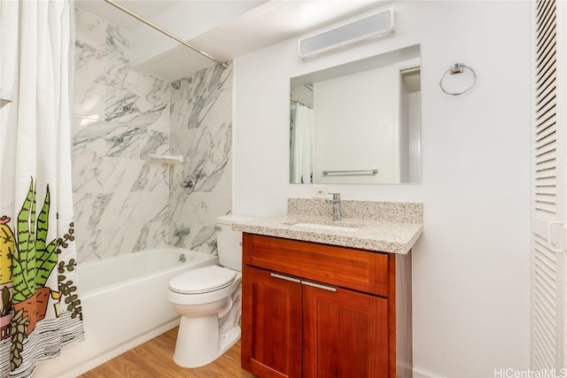 full bath featuring toilet, vanity, wood finished floors, and shower / tub combo with curtain