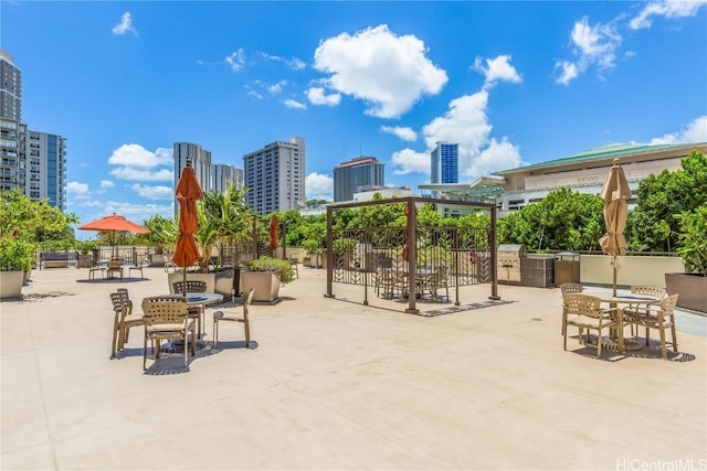 view of patio featuring outdoor dining area and a city view