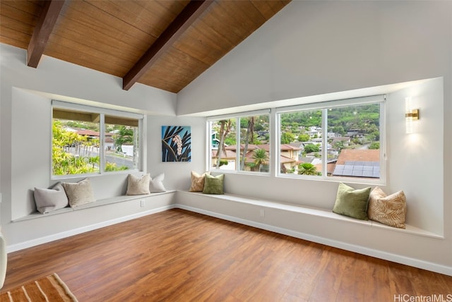 unfurnished sunroom featuring plenty of natural light, wood ceiling, and vaulted ceiling with beams