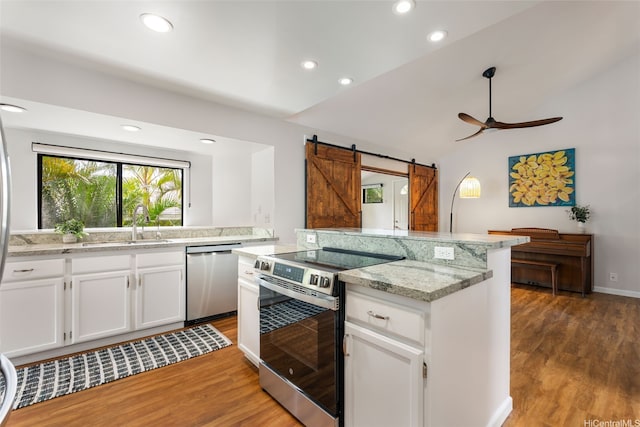 914 Kahena St, Honolulu, HI 96825 - kitchen with stainless steel appliances, a ceiling fan, light wood-style flooring, vaulted ceiling, and a sink