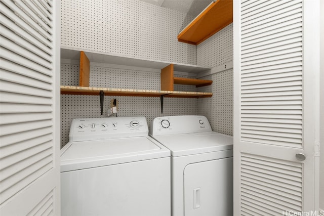 washroom featuring laundry area and washing machine and clothes dryer