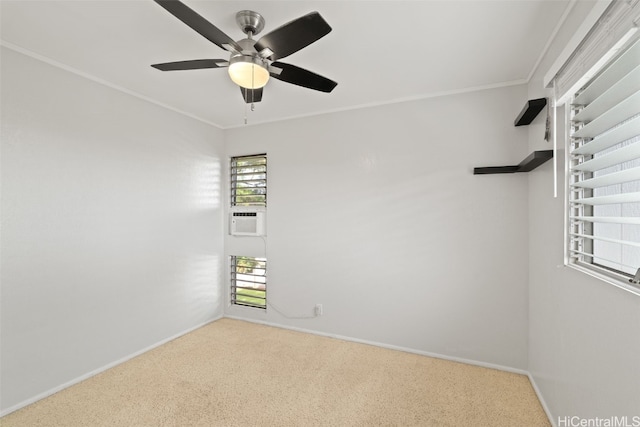 carpeted spare room featuring ornamental molding, cooling unit, a ceiling fan, and baseboards