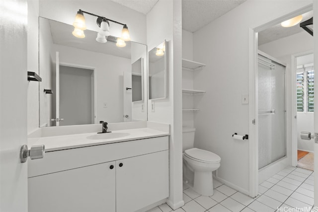 full bath with toilet, a stall shower, a textured ceiling, vanity, and tile patterned floors