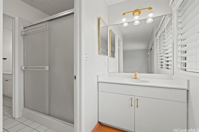 bathroom featuring a stall shower, vanity, and tile patterned floors