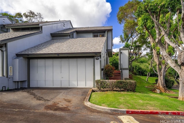 view of property exterior featuring concrete driveway, roof with shingles, and a lawn