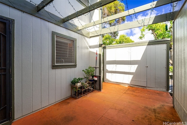 view of patio with an outbuilding and a storage shed