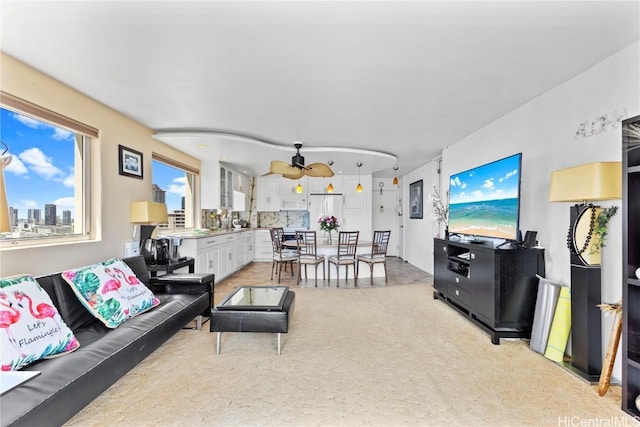 living area with ceiling fan