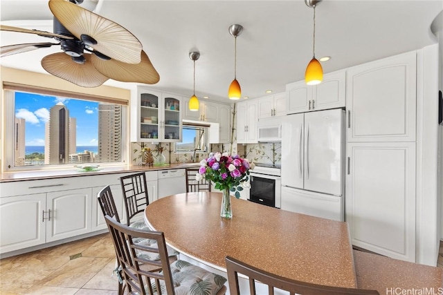 kitchen with white appliances, glass insert cabinets, and white cabinetry