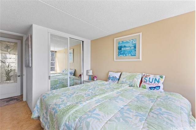 bedroom with carpet floors, a closet, and a textured ceiling