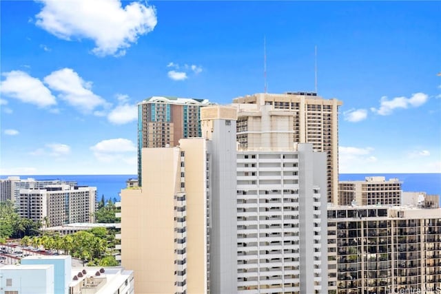 view of property with a water view and a view of city