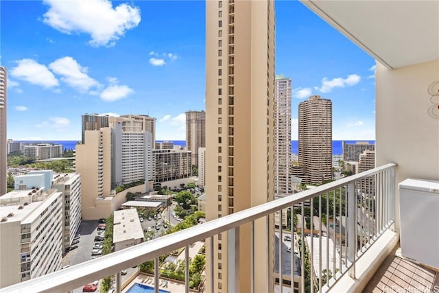 balcony featuring a water view and a city view