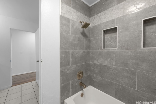 full bath featuring tile patterned floors, baseboards, and shower / bathtub combination