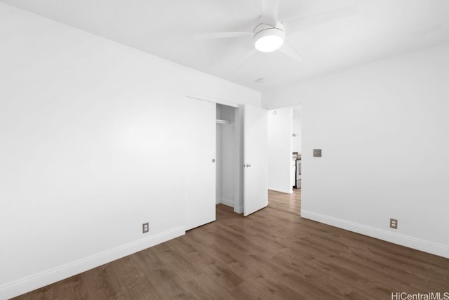 empty room featuring a ceiling fan, wood finished floors, and baseboards