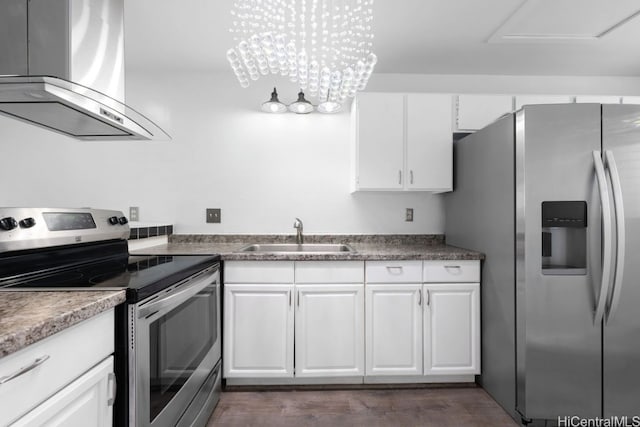 kitchen featuring a sink, appliances with stainless steel finishes, white cabinets, wall chimney exhaust hood, and dark wood-style flooring