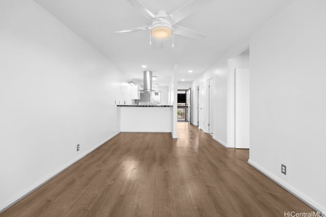 unfurnished living room featuring recessed lighting, baseboards, a ceiling fan, and wood finished floors