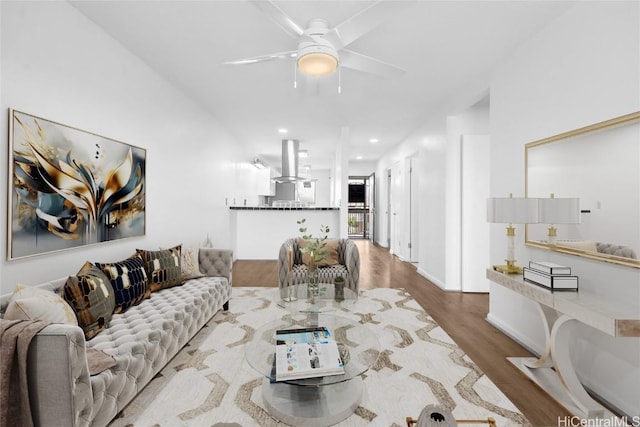 living room featuring a ceiling fan, recessed lighting, and wood finished floors