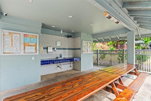 exterior space featuring concrete block wall and recessed lighting