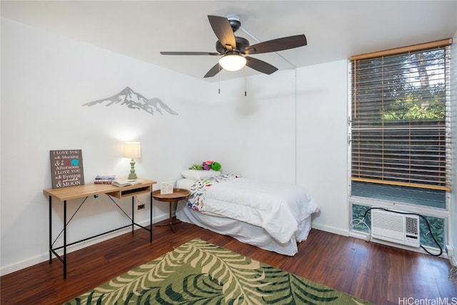 bedroom featuring ceiling fan, baseboards, and wood finished floors