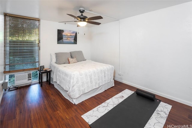 bedroom with baseboards, wood finished floors, a ceiling fan, and a wall mounted AC