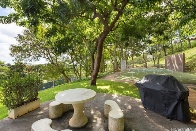 view of patio featuring a grill and fence