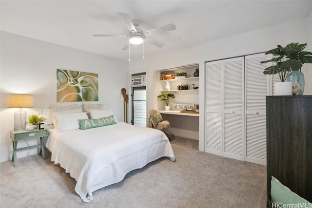 bedroom featuring ceiling fan, carpet floors, and built in desk