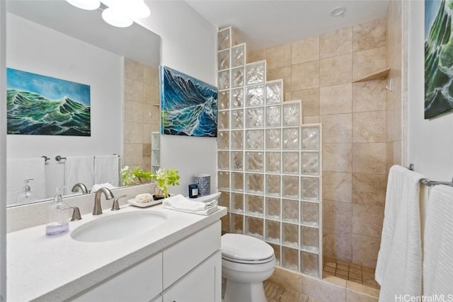 full bathroom with a walk in shower, toilet, and vanity