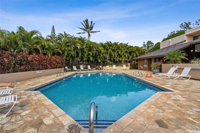 community pool featuring a patio area and fence