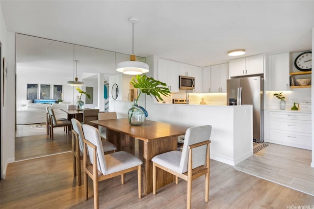 dining area with light wood finished floors